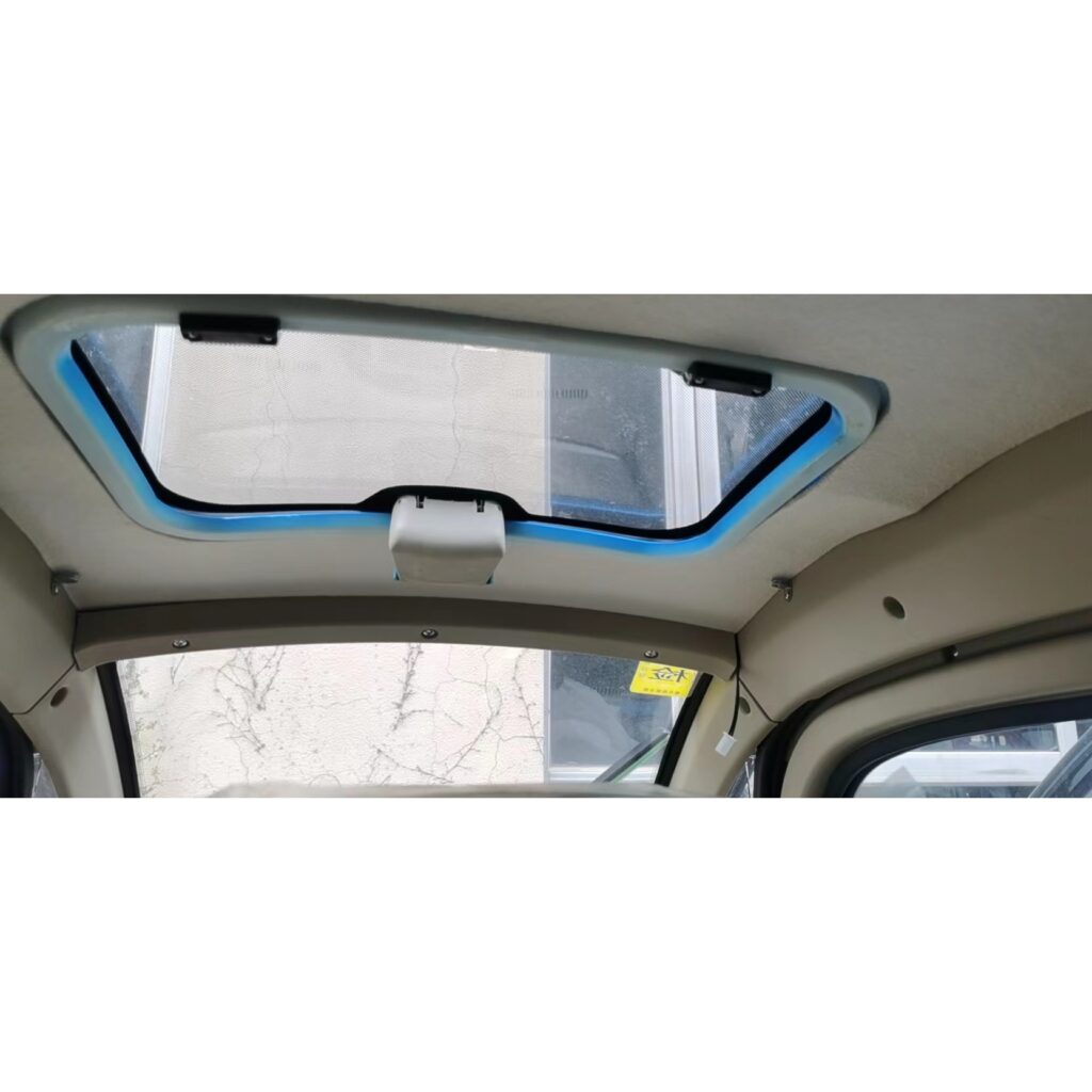 Ceiling view inside a GIO Golf mobility scooter, showing a sunroof with a blue frame.